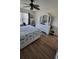 Comfortable bedroom with a ceiling fan, light-colored walls and wooden floor at 13366 Ballon Ave, Port Charlotte, FL 33981