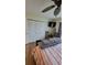 Bright bedroom featuring a ceiling fan, closet with white louvered doors, and a wall-mounted TV at 13366 Ballon Ave, Port Charlotte, FL 33981