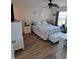 Bright main bedroom with hardwood floors, a ceiling fan, and a cozy sitting area with a scenic view at 13366 Ballon Ave, Port Charlotte, FL 33981