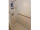 Tiled shower with handrails and mounted caddy for toiletries at 13366 Ballon Ave, Port Charlotte, FL 33981