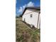 Well-maintained side yard with flowerbeds, stone mulch, and potted plants adding a touch of charm to the property at 13366 Ballon Ave, Port Charlotte, FL 33981