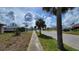 Scenic street view showcasing the neighborhood's manicured lawns, mature trees, and welcoming atmosphere at 13366 Ballon Ave, Port Charlotte, FL 33981