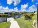 Well-maintained backyard with a concrete path to the dock at 13830 Begonia Cir, Port Charlotte, FL 33981