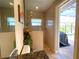 Bathroom featuring a frameless glass shower, decorated with flowers and an exterior exit to the pool at 13830 Begonia Cir, Port Charlotte, FL 33981