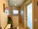 Bathroom featuring a frameless glass shower, decorated with flowers and an exterior exit at 13830 Begonia Cir, Port Charlotte, FL 33981