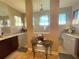 Bright bathroom with dual sinks, granite countertops, and decorative flower arrangement at 13830 Begonia Cir, Port Charlotte, FL 33981