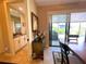 The dining room flows to an ensuite bathroom and overlooks the pool through a glass slider at 13830 Begonia Cir, Port Charlotte, FL 33981