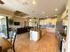 Open-concept kitchen with an island, bar seating, and stainless-steel appliances at 13830 Begonia Cir, Port Charlotte, FL 33981