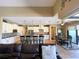 Open layout features a spacious kitchen with an island, seamlessly flowing into a comfortable living and dining area at 13830 Begonia Cir, Port Charlotte, FL 33981