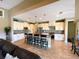 Bright and airy kitchen with island, granite counters, stainless appliances, and eat-in breakfast bar at 13830 Begonia Cir, Port Charlotte, FL 33981