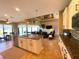 Open kitchen and living room area featuring granite countertops, stainless appliances, and views of the living area at 13830 Begonia Cir, Port Charlotte, FL 33981