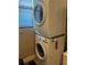 Close up view of new stacked washer and dryer with window at 13830 Begonia Cir, Port Charlotte, FL 33981