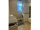 Close-up of stacked washer and dryer in laundry room with gray accent rug at 13830 Begonia Cir, Port Charlotte, FL 33981