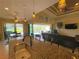 Open living room flows to screened lanai with pool views from kitchen island at 13830 Begonia Cir, Port Charlotte, FL 33981