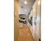 Hallway view into living space and kitchen with tile floors and ample cabinet space at 13830 Begonia Cir, Port Charlotte, FL 33981