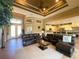 Open-concept living area with high ceilings, a ceiling fan, and views of the kitchen and backyard at 13830 Begonia Cir, Port Charlotte, FL 33981