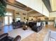 Large living area with tray ceilings, neutral colors, and seamless flow into the modern kitchen at 13830 Begonia Cir, Port Charlotte, FL 33981