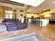 Open concept living room and kitchen with vaulted ceilings and tile flooring at 13830 Begonia Cir, Port Charlotte, FL 33981
