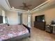 Spacious primary bedroom with tray ceiling, tiled floor, dresser, and mirror at 13830 Begonia Cir, Port Charlotte, FL 33981