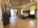 Serene main bedroom with tray ceilings, a ceiling fan, access to the lanai, and tile floors at 13830 Begonia Cir, Port Charlotte, FL 33981