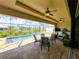 Screened patio with a covered seating area beside a pool and lake view at 13830 Begonia Cir, Port Charlotte, FL 33981