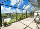 Spacious patio with comfortable seating and a screened enclosure with views of the scenic canal at 13830 Begonia Cir, Port Charlotte, FL 33981
