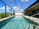 Inviting in-ground pool surrounded by a screened enclosure and a covered lanai for relaxed outdoor living at 13830 Begonia Cir, Port Charlotte, FL 33981