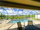 Screened-in pool area with a beautiful view of the water and surrounding landscape at 13830 Begonia Cir, Port Charlotte, FL 33981