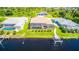 Rear view of the property with a pool, screened patio, and boat dock with canal access and serene waterway at 13830 Begonia Cir, Port Charlotte, FL 33981
