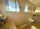 Bright shower with tile surround, built in bench, and multiple windows for natural light at 13830 Begonia Cir, Port Charlotte, FL 33981