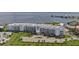 Stunning aerial view of waterfront condos with lush green spaces, parking, and coastal views at 1425 Park Beach Cir # 1310, Punta Gorda, FL 33950