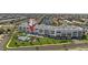 Aerial view of a modern condo building, pool, and well-maintained grounds in a waterfront community at 1425 Park Beach Cir # 1310, Punta Gorda, FL 33950