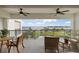 Relaxing balcony with comfortable seating, ceiling fans, and a scenic view of the bay and park at 1425 Park Beach Cir # 1310, Punta Gorda, FL 33950