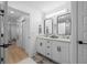 Dual sinks, vanity, and walk-in shower area with access to hallway at 1425 Park Beach Cir # 1310, Punta Gorda, FL 33950
