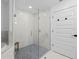 Shower with glass surround and stone floor tiling at 1425 Park Beach Cir # 1310, Punta Gorda, FL 33950