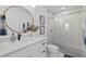 Modern bathroom featuring marble shower, white vanity with gold accents, and tasteful nautical decor at 1425 Park Beach Cir # 1310, Punta Gorda, FL 33950