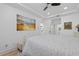 Bright bedroom with coastal decor, tray ceilings, light hardwood floors and plantation shutters at 1425 Park Beach Cir # 1310, Punta Gorda, FL 33950