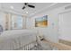 Well-lit bedroom with coastal decor, tray ceilings, light hardwood floors and plantation shutters at 1425 Park Beach Cir # 1310, Punta Gorda, FL 33950