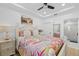 Comfortable bedroom with a vibrant bedspread, bright natural light, and an ensuite bathroom at 1425 Park Beach Cir # 1310, Punta Gorda, FL 33950