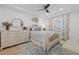 Bright bedroom with tray ceiling, ceiling fan, light wood floors, and beachy decor at 1425 Park Beach Cir # 1310, Punta Gorda, FL 33950