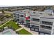 Multi-story condo building with a modern design, featuring balconies, a flat roof, and manicured landscaping at 1425 Park Beach Cir # 1310, Punta Gorda, FL 33950