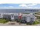 Stunning waterfront condo building with lush landscaping, offering breathtaking coastal views at 1425 Park Beach Cir # 1310, Punta Gorda, FL 33950