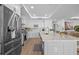 Modern kitchen featuring white cabinets, stainless steel appliances, and a spacious center island with seating at 1425 Park Beach Cir # 1310, Punta Gorda, FL 33950