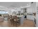 Open kitchen with island seating, stainless steel appliances, and an adjacent living area with water views at 1425 Park Beach Cir # 1310, Punta Gorda, FL 33950