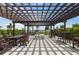Inviting outdoor lounge area with pergola, BBQ grill, and seating overlooking the water at 1425 Park Beach Cir # 1310, Punta Gorda, FL 33950