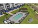 Aerial view of community pool with lounge chairs, tables, and a pergola for a relaxing outdoor experience at 1425 Park Beach Cir # 1310, Punta Gorda, FL 33950