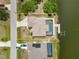 Aerial view of a waterfront property featuring a private pool and dock at 15104 Aldama Cir, Port Charlotte, FL 33981