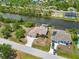 A property with a large driveway, well-maintained landscaping, and direct access to a picturesque canal waterway at 15104 Aldama Cir, Port Charlotte, FL 33981