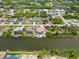 A community of homes with private docks, pools, and lush vegetation lining the tranquil canal waterways at 15104 Aldama Cir, Port Charlotte, FL 33981