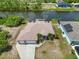 Aerial view of a home with a spacious layout, a screened-in pool, and access to a serene canal waterway at 15104 Aldama Cir, Port Charlotte, FL 33981